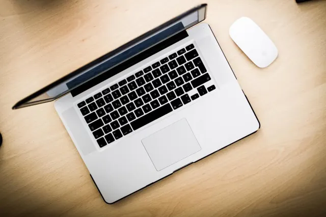Laptop and wireless mouse seen from above