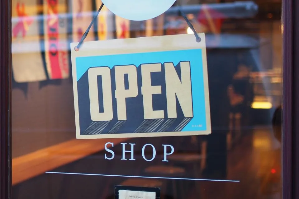 Open sign hanging on a shop door