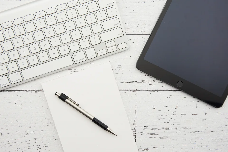 Keyboard, tablet and pen on a white table
